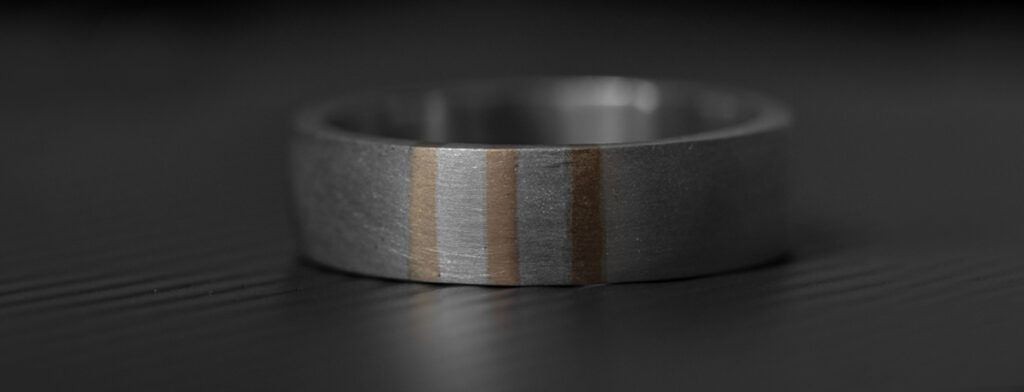 This minimalist wedding band for men began life as a commissioned piece for one of our clients, Ross. He was getting married – of course – and was looking for a more masculine wedding ring than the ones he had seen in the various high street jewellers.